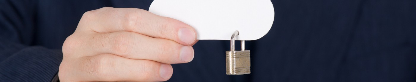 hand holding a paper cloud with a padlock hooked to it.